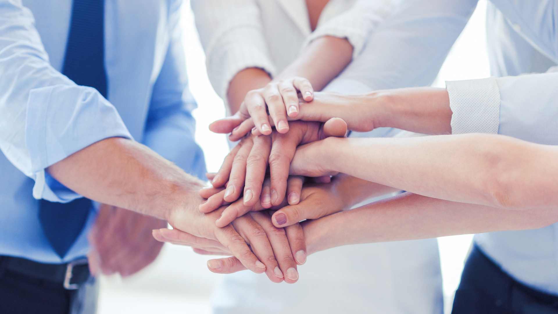 Hands stacked in a team huddle
