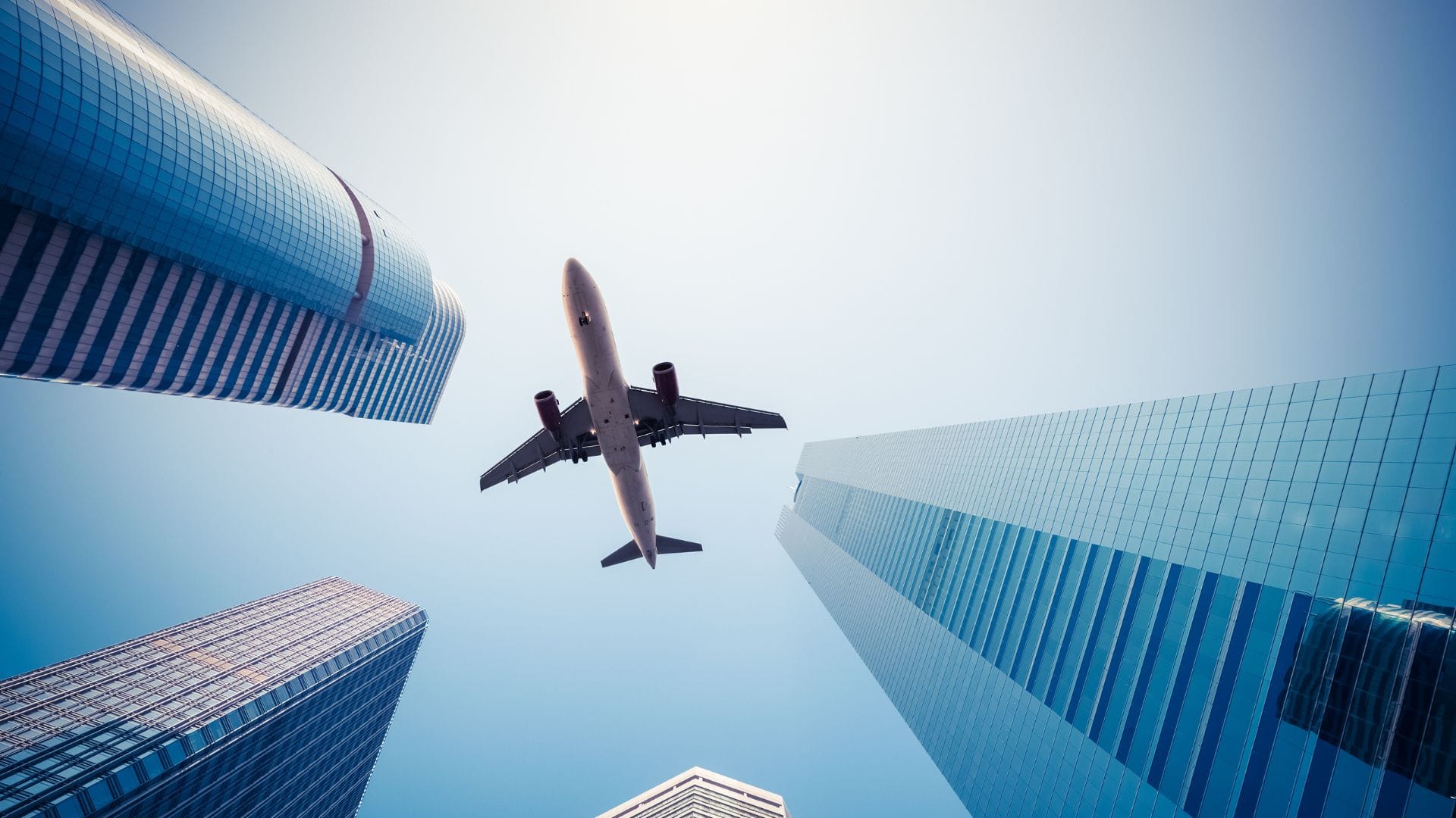 A plane flying above a cityscape