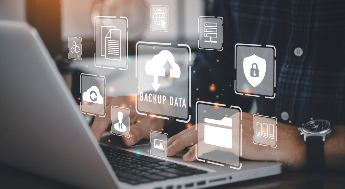 Abstract image of icons related to data backup coming out of a computer