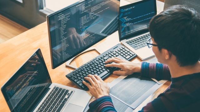 Person working at a computer with multiple screens